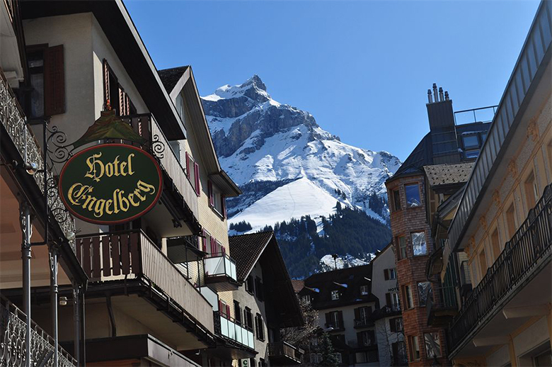 Street view of Hotel Engelberg with snowy mountain peaks in the background