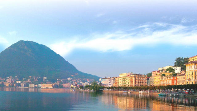 View of Lugano city and the mountains from lake Lugano