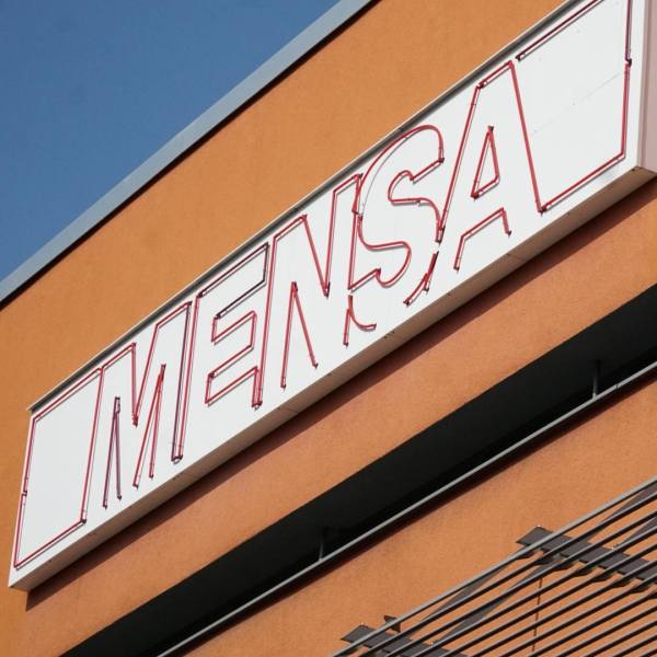 Facade of TU Mensa with huge Neon Sign reading "MENSA"